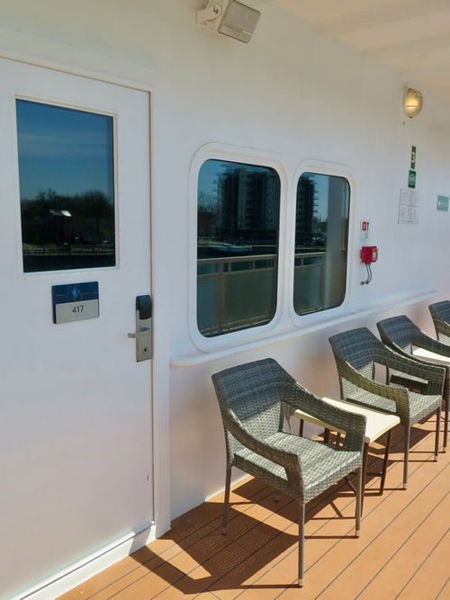 A deluxe outside stateroom with a veranda that is shared with other staterooms on Deck 4. A deluxe outside stateroom with a veranda that is shared with other staterooms on Deck 4.