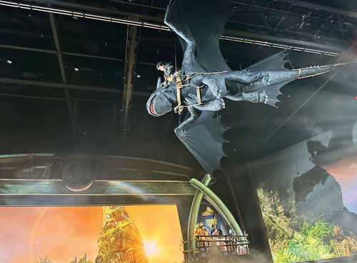 Hiccup and Toothless fly above the audience during "The Untrainable Dragon."