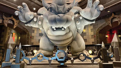 A statue of Bowser inside the queue of Mario Kart: Bowser’s Challenge, a coaster at the new Epic Universe.