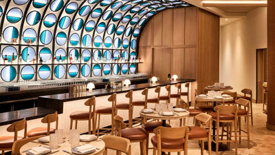 The back bar at Zaytinya is built with a glass structure that is symbolic of the Greek evil eye.