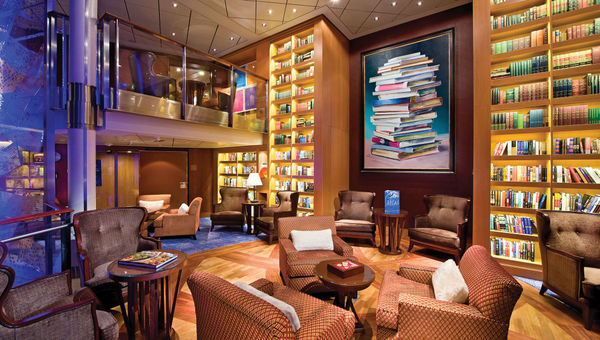 The Celebrity Solstice features a cozy, thoughtfully designed library space with beautiful floor-to-ceiling bookcases.