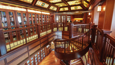 Cunard's Queen Victoria library features elegant two-story design, rich wood paneling and a stained-glass ceiling.
