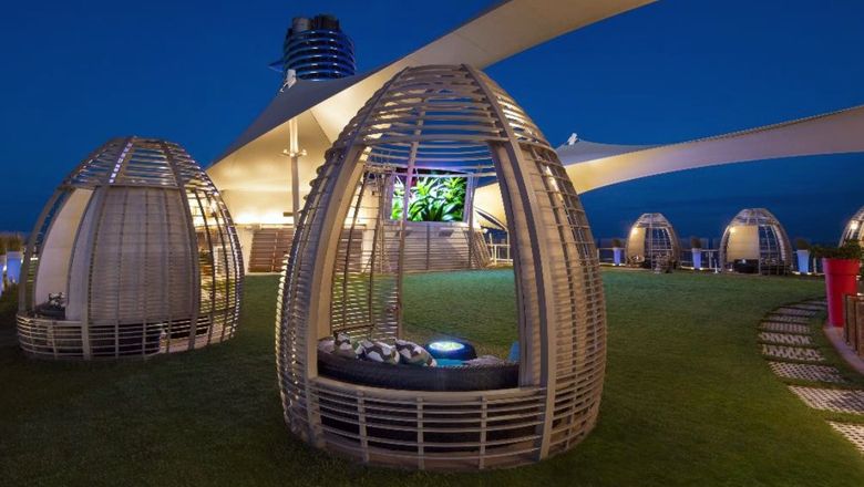 Cabanas on the Lawn Club of the Celebrity Equinox. The line plans to swap out its grassy lawn for turf and add new amenities.