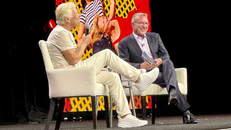 Travel Leaders Network president John Lovell, right, speaks with Richard Branson, founder of Virgin Group, on stage during the network’s Edge conference at Caesars Palace Las Vegas Hotel and Casino.