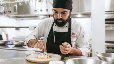 Chef Cristian Puente oversees culinary programming across Pikaia Lodge and the Vision Pikaia yacht.