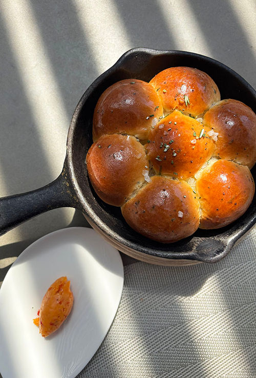 Every meal at Moxi begins with a hot skillet of warm brioche buns. Every meal at Moxi begins with a hot skillet of warm brioche buns.