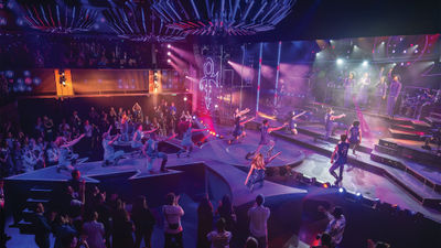 Norwegian's "Revolution: A Celebration of Prince" features moveable stage pieces that transform into the artist's famous symbol.