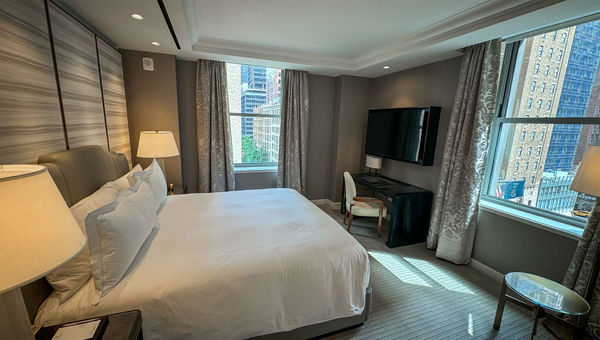 The bedroom of a one-bedroom king suite at the hotel.