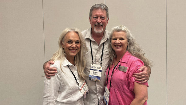 Travel advisor Jami Turner of The Travel Fanatic, left, poses with Robin and Stella Mountain of Ntaba African Safaris.