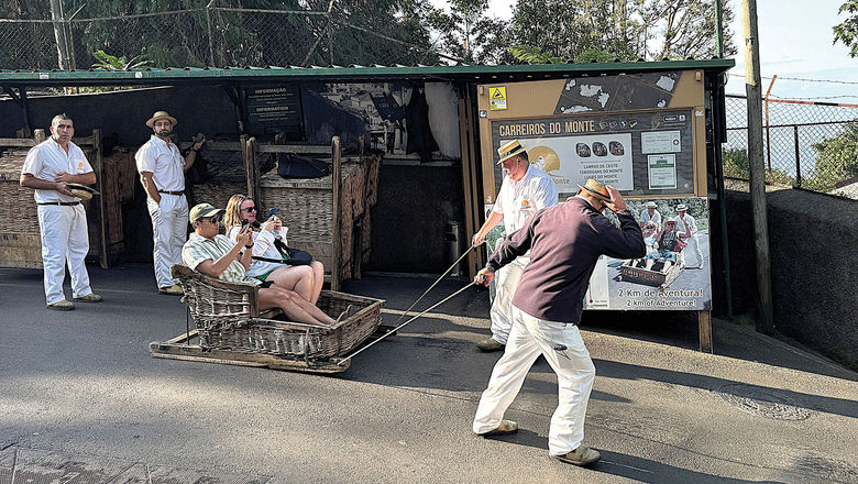 Visitors prepare for a wild ride down Funchal streets in the comfort of a wicker toboggan.