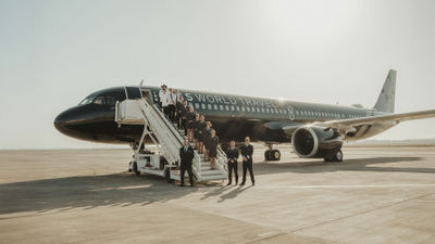 TCS World Travel's Airbus A321 jet and staff.