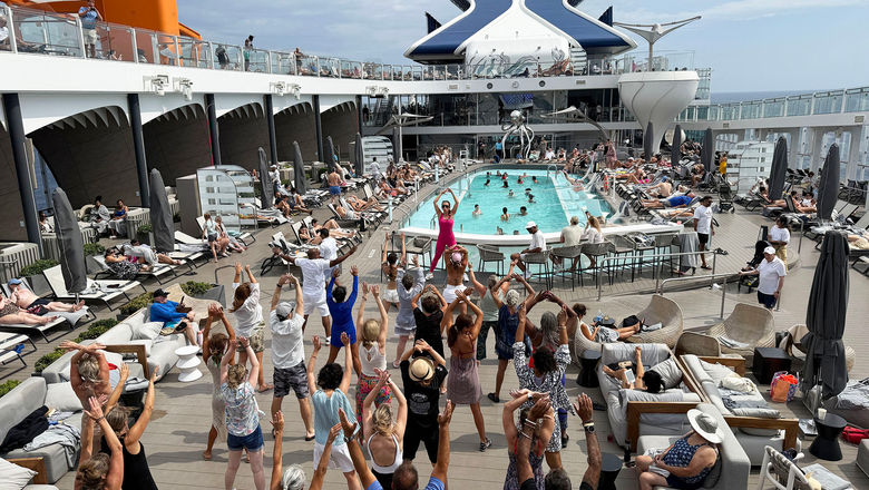 Celebrity Ascent cruise director Alexa Helsby-Lue leads a dance workout class on the pool deck. Like the class I tried, which was held in the same pool, her voice and the music was blasting for anyone outside to hear.