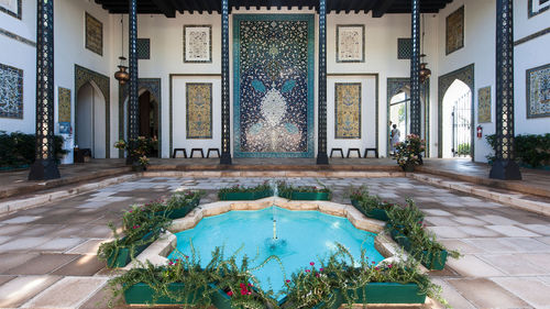 The home is built around a large courtyard with entries to public spaces, such as the living room and pool, connecting from there.