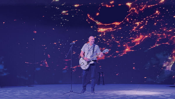 The Xcel's captain, Kyriakos Matragkas, plays the guitar in the unfinished ship's theater. The Xcel's captain, Kyriakos Matragkas, plays the guitar in the unfinished ship's theater.