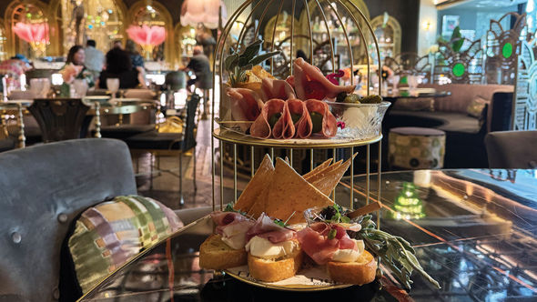 A charcuterie platter served in a golden birdcage at Pinky's by Vanderpump at the Flamingo Las Vegas.