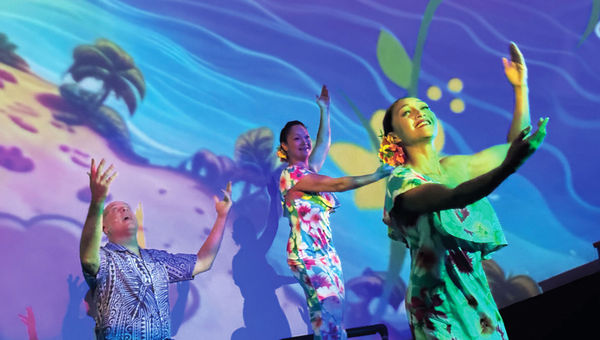 Entertainer Eric Gilliom is joined by dancers and musicians during the Maui Ocean Center's "Mele: The Hawaiian Music Experience" performance.