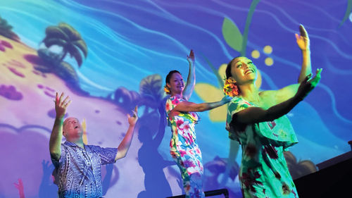 Entertainer Eric Gilliom is joined by dancers and musicians during the Maui Ocean Center's "Mele: The Hawaiian Music Experience" performance.