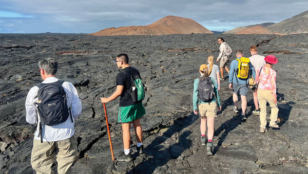 Passengers from the Gemini explore the lava rock landscape of the Galapagos. Passengers from the Gemini explore the lava rock landscape of the Galapagos.