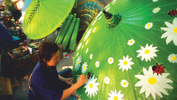 In Bo Sang village, artisans create colorful, hand-painted parasols from bamboo and paper.