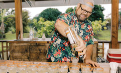 A bartender prepares a round of mai tais for guests taking the Kauai Rum Safari Tour at Kilohana Plantation.