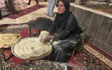 A woman demonstrates how to make bread at the opening party of the GX Summit in Amman, Jordan.