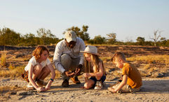 A Cheetah Plains guide leads young guests in a Junior Ranger activity, part of the lodge’s new family-focused programming in South Africa’s Sabi Sand Nature Reserve.