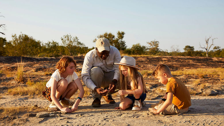 A Cheetah Plains guide leads young guests in a Junior Ranger activity, part of the lodge’s new family-focused programming in South Africa’s Sabi Sand Nature Reserve.