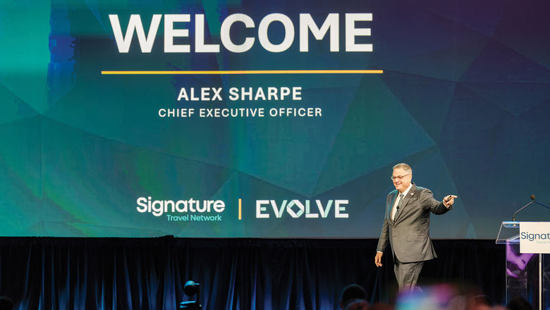 Signature Travel Network CEO Alex Sharpe on stage at Signature's annual conference.