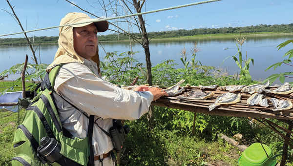 Pure Amazon guide Robinson shows guests how locals dry fish.