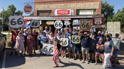 Travelers pose in front of the Sandhills Curiosity Shop, a Route 66 attraction in Erick, Oklahoma.