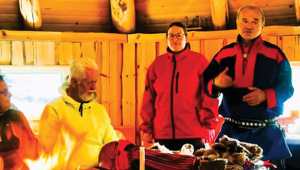 A Sami elder and an interpreter share customs of the Indigenous people. A Sami elder and an interpreter share customs of the Indigenous people.