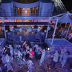 Mitsui Ocean Cruises passengers dance on the deck of the Ocean Fuji during the summer festival party.