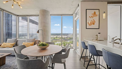 A living and dining area in an Apartment Collection by Hilton furnished apartment.