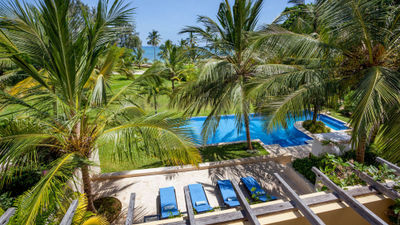 The pool at Tribe Beach House in Kilifi, set among palm trees on Kenya’s unspoiled coast.