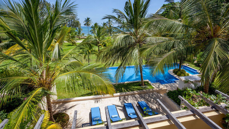 The pool at Tribe Beach House in Kilifi, set among palm trees on Kenya’s unspoiled coast.