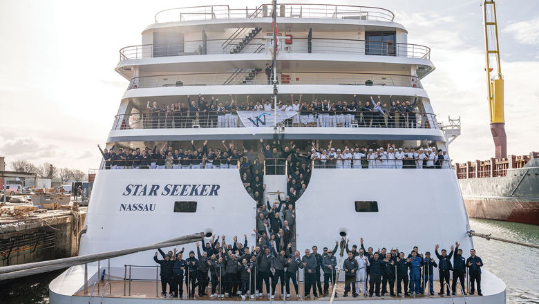 The crew takes a photo on the deck of the ship, which is the first in the Windstar Cruises fleet to be built in the 21st century.
