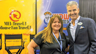 Beci Mahnken, owner of MEI-Travel and Mouse Fan Travel, with Josh D’Amaro at her D23 Expo booth.
