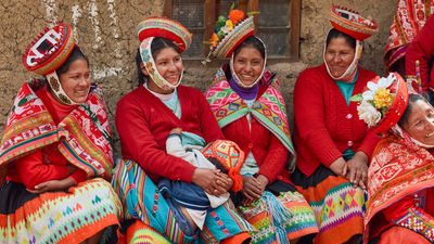 Peruvian women in traditional, colorful dress.