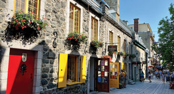A narrow cobblestone street with colorful signs and shops, Rue du Petit-Champlain is the oldest commercial street in North America.