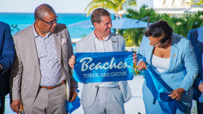 Sandals executive Adam Stewart (center) at the ribbon-cutting for Treasure Beach Village at the Beaches Turks and Caicos.