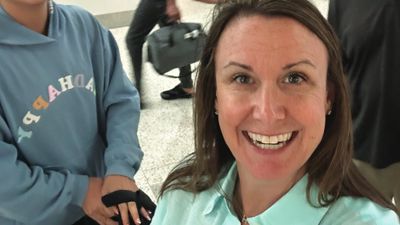 Travel agency owner Jeanne Polocheck was smiling even though she missed her flight at Houston Bush Intercontinental Airport after a long wait on the TSA security line.