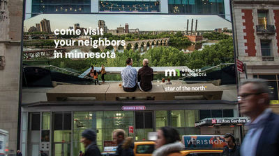 A billboard in midtown Manhattan featuring messaging from Explore Minnesota's "Come Visit Your Neighbors in Minnesota" campaign.