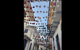 Colorful Panama hats hanging above a street in old town.