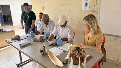 Community leaders sign a memorandum of commitment at a school in Colombia.