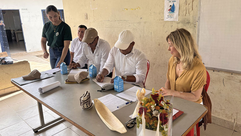 Community leaders sign a memorandum of commitment at a school in Colombia.