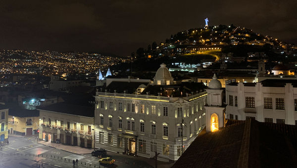 The hotel at night with Virgin of El Panecillo in the background.