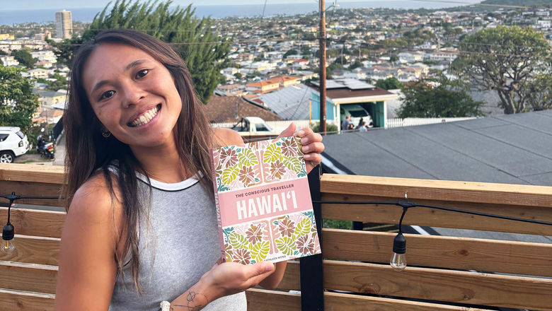 Kathleen Wong with her book The Conscious Traveller Hawaii.