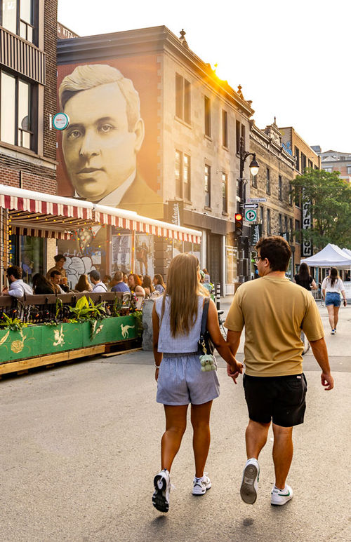 Le-Plateau-Mont-Royal during summer street closures framed by "The Angel of Bordeaux" mural by artist Matthew Cadoch. Le-Plateau-Mont-Royal during summer street closures framed by "The Angel of Bordeaux" mural by artist Matthew Cadoch.