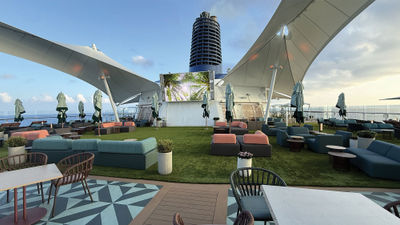 The new Sunset Park on Deck 15 includes an artificial turf lawn, cabanas, plenty of seating, a movie screen and the Sunset Park Cafe.