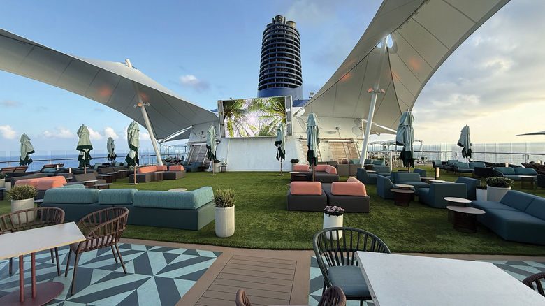 The new Sunset Park on Deck 15 includes an artificial turf lawn, cabanas, plenty of seating, a movie screen and the Sunset Park Cafe.